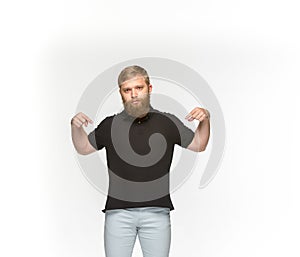 Closeup of young man`s body in empty black t-shirt isolated on white background. Mock up for disign concept