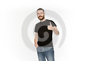 Closeup of young man`s body in empty black t-shirt isolated on white background. Mock up for disign concept