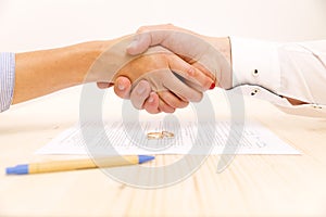 Closeup of a young man an a young woman shaking hands