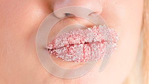 Closeup on young pretty woman with beautiful lips in sugar