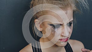 Closeup of young teenage girl dancer crying after loss perfomance sits on floor in dance studio indoors