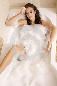 Closeup of young woman in bathtub bathin photo