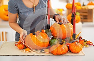 Closeup on young woman decorating kitchen for halloween.