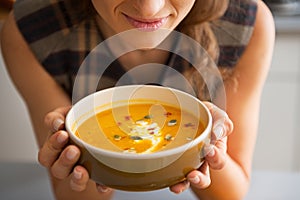 Closeup on young woman enjoying pumpkin soup