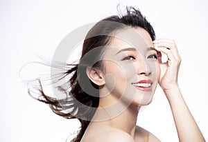 Closeup young Woman face with hair motion on white background