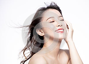 Closeup young Woman face with hair motion on white background