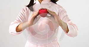 Closeup of young woman hands with ball heart shape