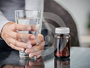 Closeup young woman holding drinking water glass in her hand