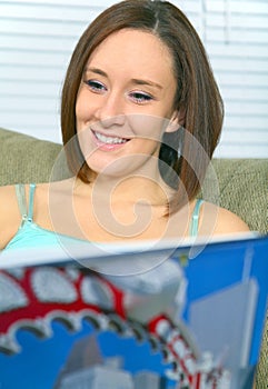 Closeup Young Woman Reading Book And Smiling