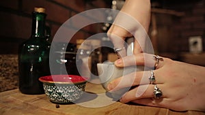 Closeup: Young woman`s hands grind spices using a Mortar and Pestle