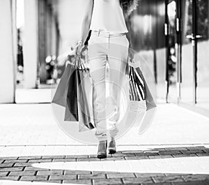 Closeup on young woman with shopping bags on the mall alley