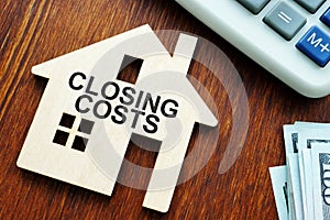 Closing costs. Model of house and money