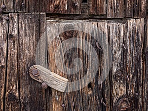 Closing details of an old wooden barn door