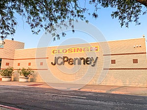 Closing sign at facade building of J.C. Penney retail store in shopping mall near Dallas, Texas, America