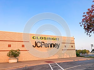 Closing sign at facade building of J.C. Penney retail store in shopping mall near Dallas, Texas, America