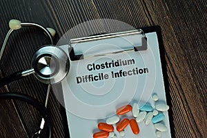 Clostridium Difficile Infection write on sticky notes isolated on Wooden Table. Medical or Healthcare concept photo