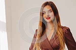 Closup portrait attractive stylish young girl near the window in light interior