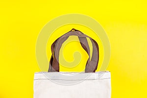 Cloth bag shopping bag isolated on yellow background.Stop using plastic bags