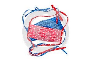 Cloth Face Masks for Covid19 pandemic protection that are handmade and in red, white, and blue cotton fabric isolated on white bac photo