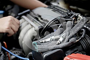 Cloth gloves and car spark plug on engine,Technician service and repairing