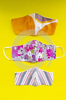 Cloth mask or fabric face mask with cotton fabric flower pattern handmade crafts isolated on white background. This hygienic mask.