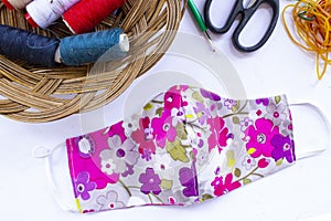 cloth mask or fabric face mask with cotton fabric flower pattern handmade crafts isolated on white background. This hygienic mask.