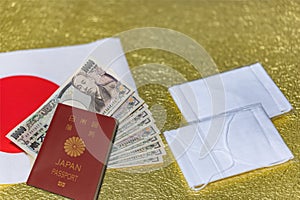 Cloth masks, 100000 yen in cash with a passport on a Japan flag and golden paper.