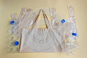 On the cloth reusable bag lie cellophane disposable bags, gloves