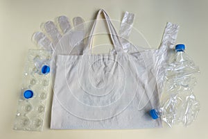 On the cloth reusable bag lie cellophane disposable bags, gloves