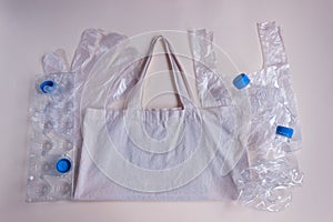 On the cloth reusable bag lie cellophane disposable bags, gloves