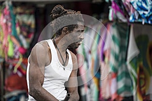 Cloth seller, Rastafari, Port Antonio, Jamaica. Colorful fabrics in front of vendor stall, Jamaica