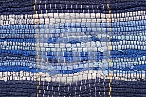 Cloth sewn from strips of fabric. Needlework, reuse of materials. Blue strips in a marine style.