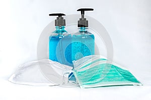 Cloth and surgical face masks with alcohol hand sanitizer gels for protecting covid-19 virus inflection on white background