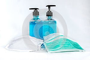 Cloth and surgical face masks with alcohol hand sanitizer gels for protecting covid-19 virus inflection on white background photo
