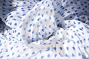 Cloth. White fabric with blue hearts, textile background