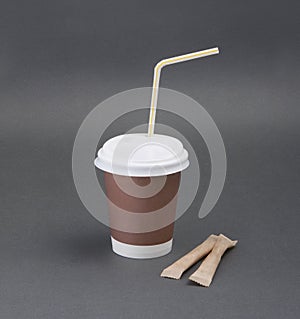 Clotheded take-out coffee with cup holder on gray background.