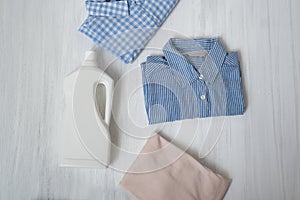 Clothes and bottle with detergent. Top view