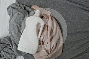Clothes and bottle with detergent. Top view