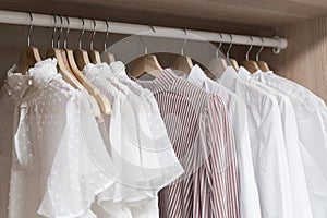 Clothes in the closet. Women& x27;s light vintage clothes on hangers in the closet of the dressing room. Fashion trends