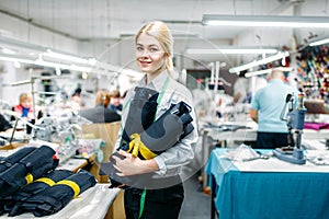 Clothes designer holding fabric textile in hands