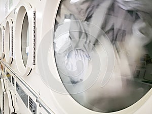 Clothes in dryer machine Doing laundry at laundromat