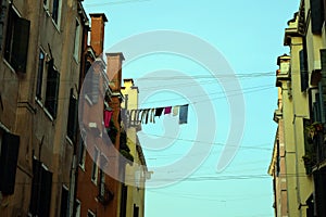 Clothes drying on a clothesline between two buildings in Venice