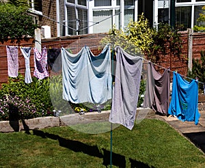 Clothes drying on a domestic line in a back garden