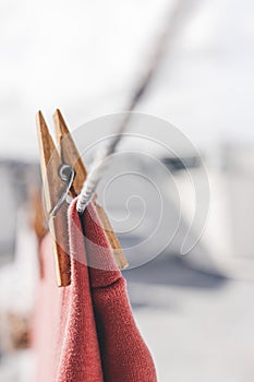 Clothes drying outdoors. Close-up wooden clothespin. Clothes hanging rope