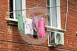 Clothes drying on a rope under a window