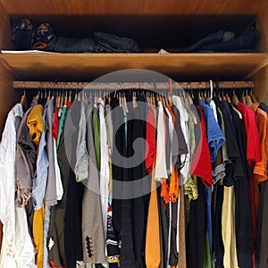 Clothes in full wardrobe