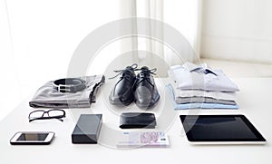 Clothes, gadgets and business stuff on table