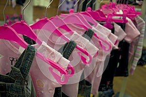 Clothes hang on hangers in shop