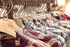 Clothes hang on a shelf . Cloth Hangers with Shirts. Men`s stylish clothes