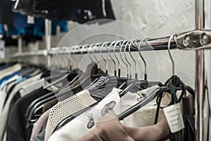 Clothes hang on a shelf in a clothes store